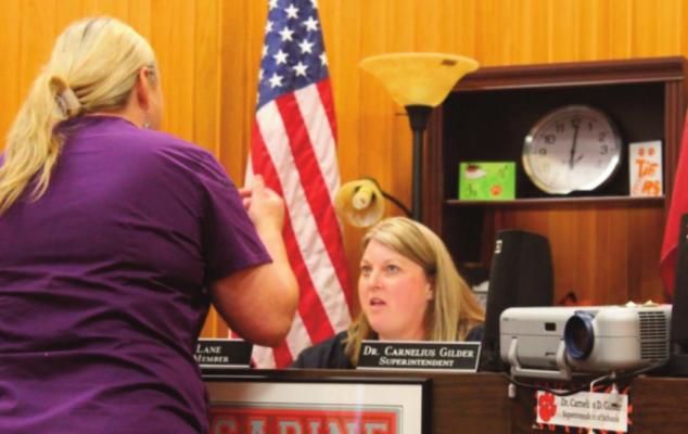 Meeting... Tammy Rogers, Child Nutrition Director discusses summer feeding program with Lisa Lane at WS board meeting. Reporter photo by Kenny Wick