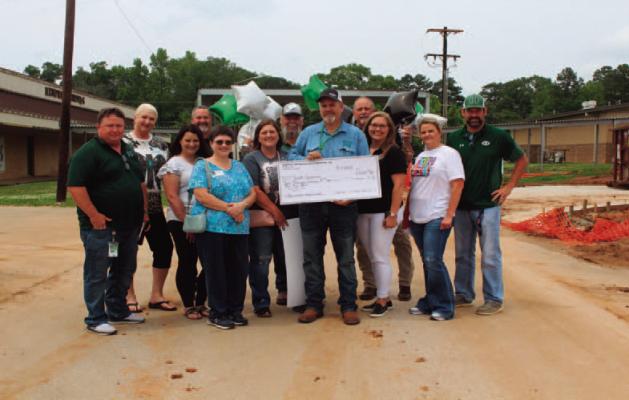 The Education Foundation delivered grants to 5 lucky recipents last week. One of the lucky ones was Mr. Scott Simmons who is an Ag teacher for Hemphill ISD. He plans to put his money to use by purchasing items to build a Chicken coop to have kids help raise them. If you would like to see a complete list of pictures and recipients, check out sabinecountyreporter. com Reporter photo by Samantha Hill