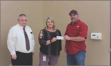 Tracy Lane PSC V.P. and Kim Rhame PSC President donate to Joey Quick Dixie League Sect. Reporter photo by Kenny Wick