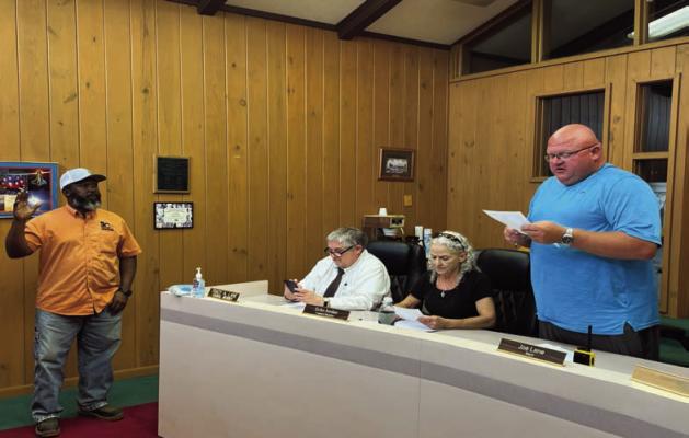 Swearing In... Pineland Mayor Joe Lane swears in newly appointed Councilman Demond Williams at a May 25 special meeting. Reporter photo by Cecil Tatom