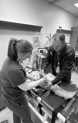 Jenny Day, RN, and Brian Corley, RN, working on clinical skills.