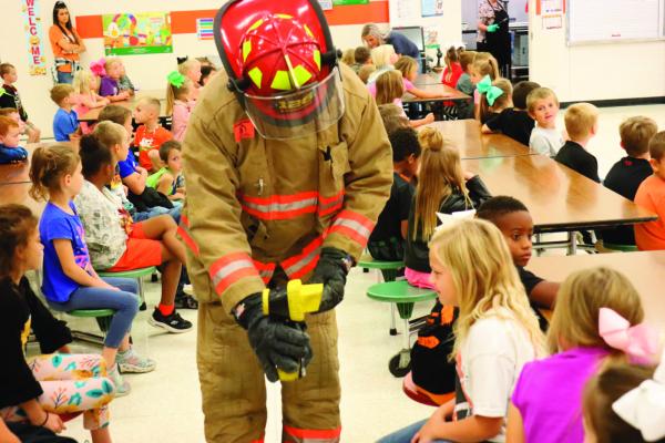 PINELAND VFD FIREFIGHTER B A FITZGERALD DEMONSTRATES THE THERMAL IMAGING CAMERA TO WEST SABINE 2ND GRADER LYNNLEY REKEITA