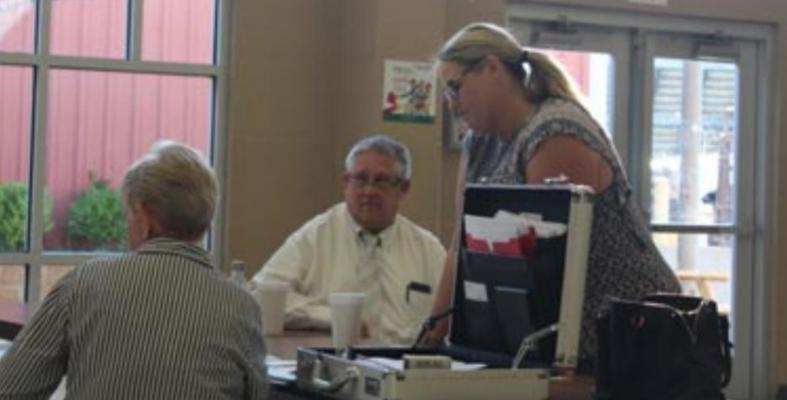 Pineland Service Club... (left to right) Treasurer/Secretary Janice Giley, Vice President T.A. Lane, and President Kim Rhame discuss festival dates. Reporter photo by Kenny Wick .