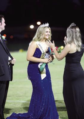 Last year’s queen, Cami Allman crowns Lilly McGee in the pregame ceremony for Homecoming Friday night. McGee was escorted by Seth English and the Hornets reigned victorious over Merryville with a final score of 44-12. Reporter photos by Johanna Vickers