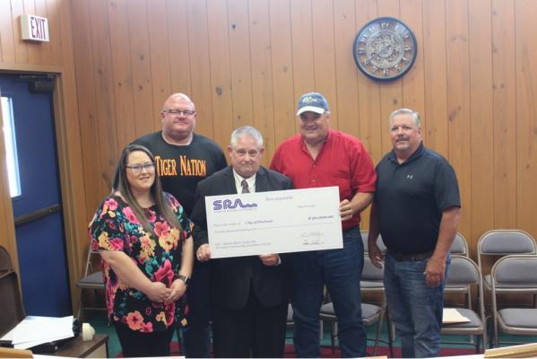 Community... L - R City Administrator Melissa Jones, Mayor Joseph Lane, Mayor Pro-Tem T A Lane, SRA Board President Tom Beall, and SRA Middle Basin Manager Don Iles Reporter photo by Kenny Wick