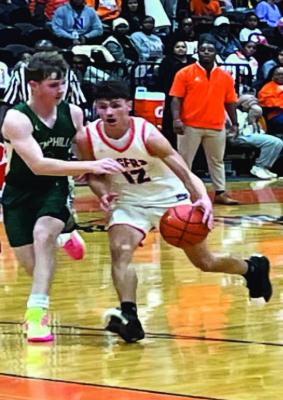 Tiger G Tyler Streigel drives it up the court Friday night against Hemphill. Hemphill won with a final score of 57-41 Reporter photo by Cecil Tatom