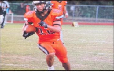 Rounding the corner... WS RB Kameron Striegel dashes around left end for a big gain against Trinity Friday. Reporter photo by Cecil Tatom