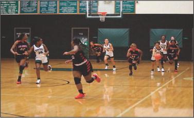 The San Augustine Lady Wolves started fast and never let up, running away with a 68-25 win over the Lady Hornets Tuesday evening. #20 Welch starts a Hemphill fast break in the second quarter, supported by #22 Williams, #30 Price, #0 Corley, and #23 Strother. Williams led Lady Hornet scoring with 9 points. Hemphill will be in action at home on the 29th against Shelbyville, then in West Sabine for the Witherspoon Classic Tournament December 1-3. Reporter photo by Bill Dodson